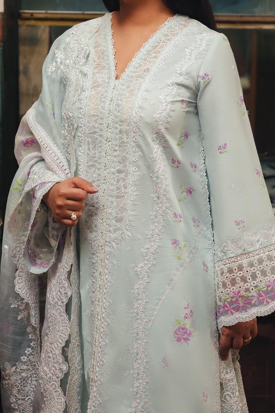 Crafted from premium cambric cotton, this piece features intricate embroidery on the front, back, and sleeves