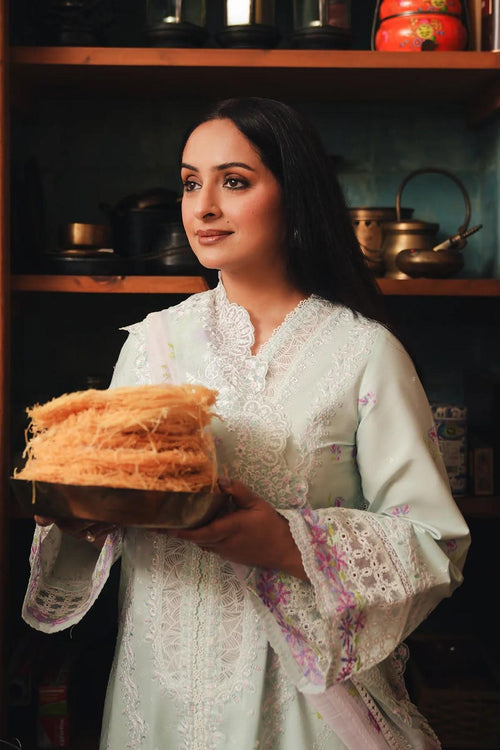 Crafted from premium cambric cotton, this piece features intricate embroidery on the front, back, and sleeves