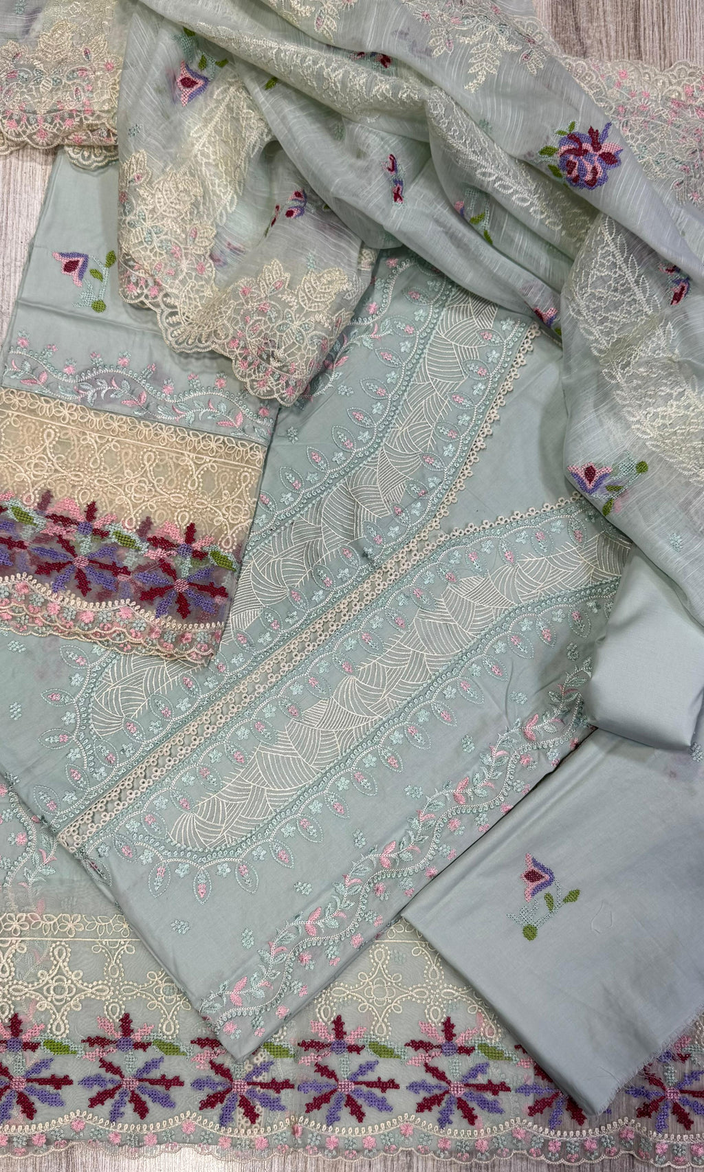 Crafted from premium cambric cotton, this piece features intricate embroidery on the front, back, and sleeves
