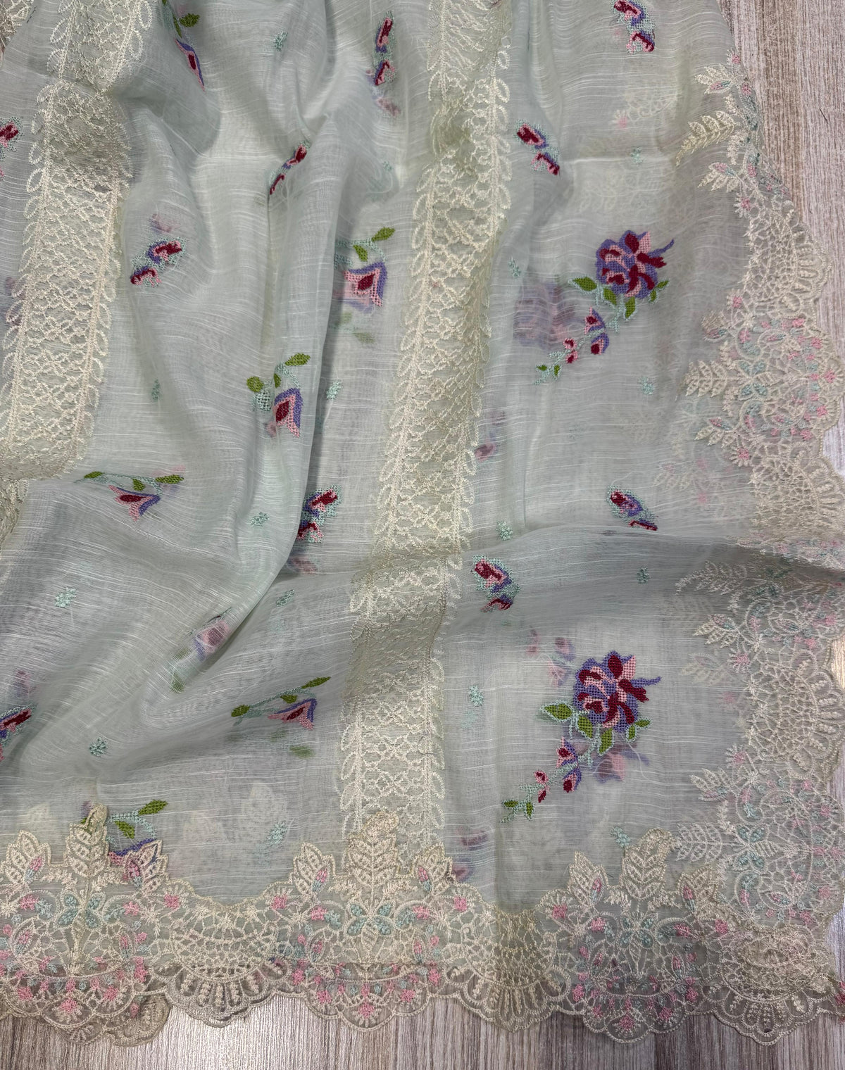Crafted from premium cambric cotton, this piece features intricate embroidery on the front, back, and sleeves