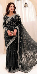 Exquisite net saree adorned with intricate embroidery featuring sequins, stones, and pearls throughout