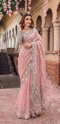 Elegant net saree featuring exquisite embroidery with sequins, stones