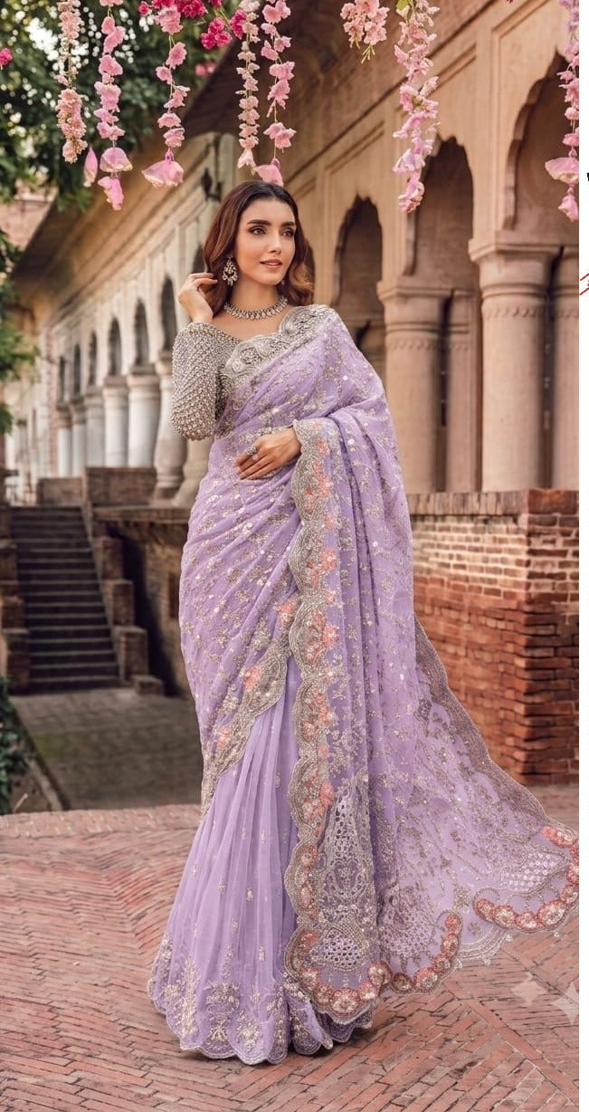 Elegant net saree featuring exquisite embroidery with sequins, stones