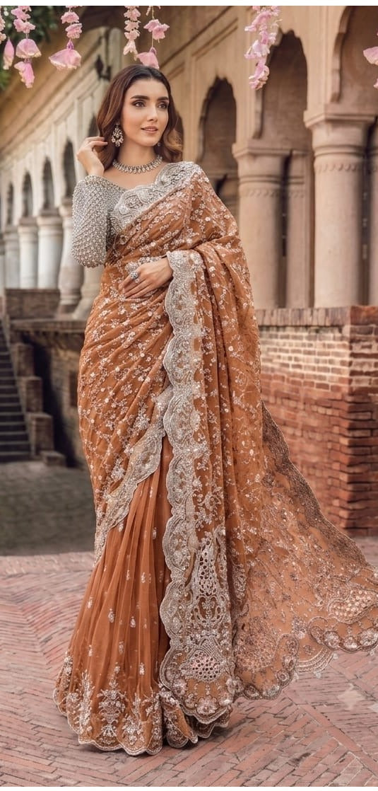 Elegant net saree featuring exquisite embroidery with sequins, stones